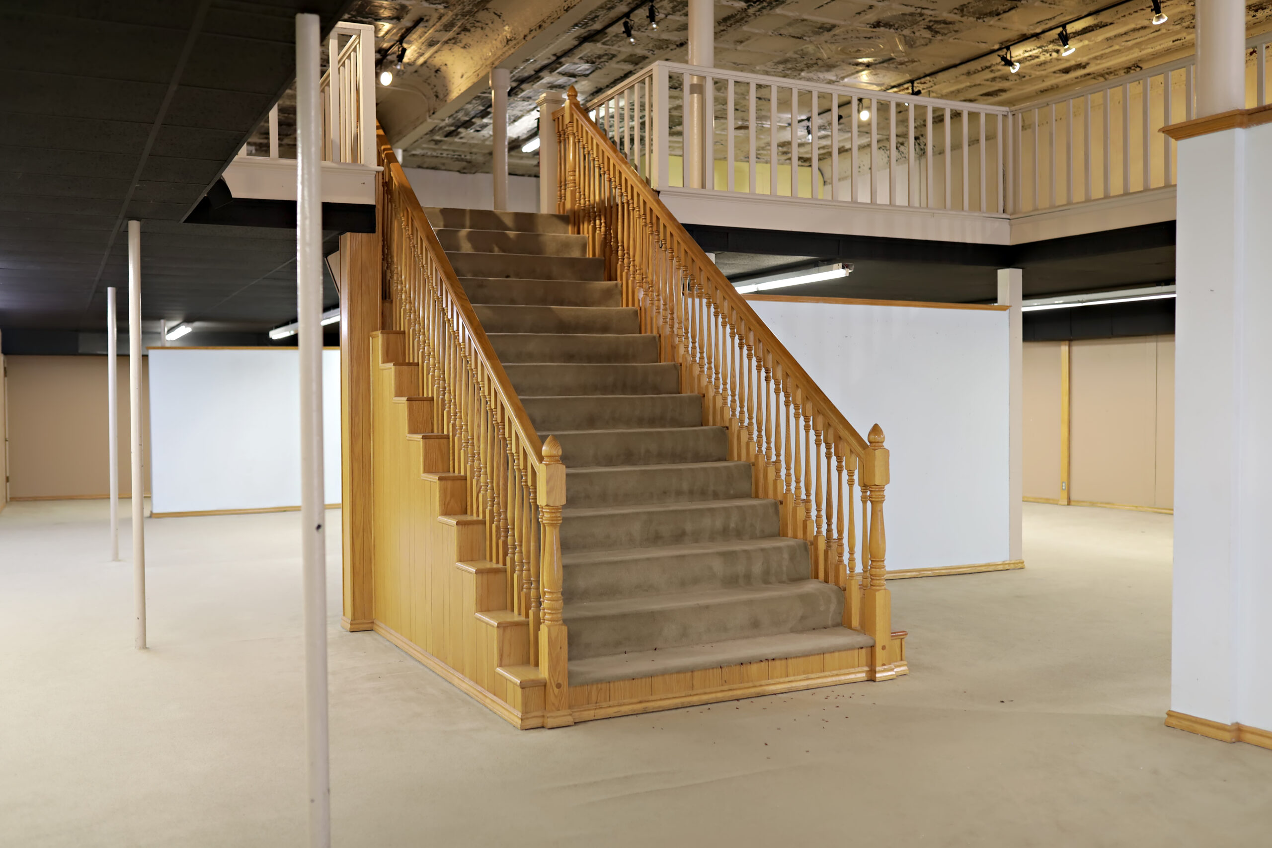 Interior staircase in the primary space of The Guilded Grayland